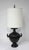 A very well crafted darken bronze table lamp with incised designs to the upper neck area and ribbed body having unique...