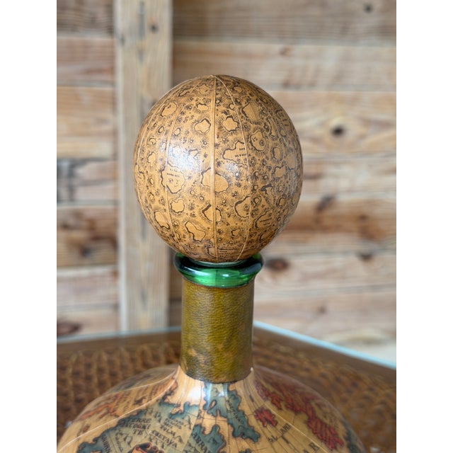 A charming vintage Italian liquor decanter by Florentia, featuring an elaborate antique-style world map inspired by early...