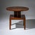 Art Deco side table in walnut with a square base raised on four legs. Above rises a cross-shaped intermediate column,...
