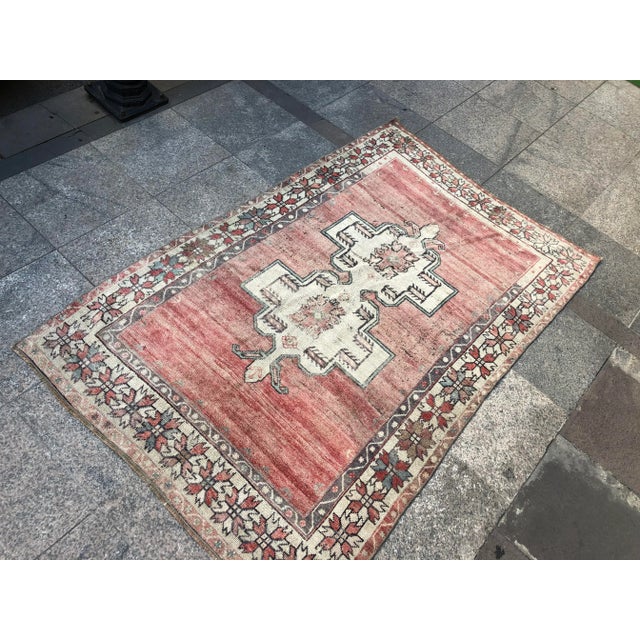 This is a vintage Turkish Oushak rug from the 1960s. The piece was hand-knotted.