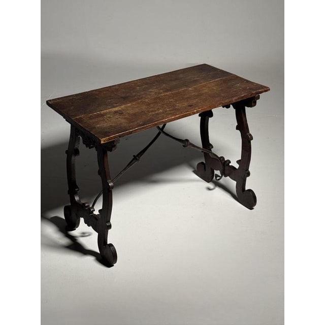 Italian console / side table. Early 19th century, ca. 1800. Crafted from solid hardwood with wrought iron elements on the...