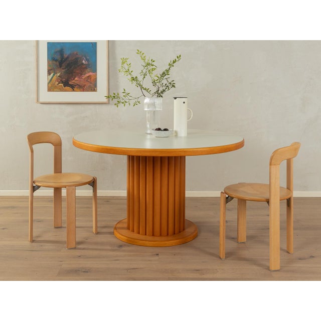 A wonderful dining table by Flötotto from the 1980s. High-quality construction consisting of a cream-white Formica-coated...