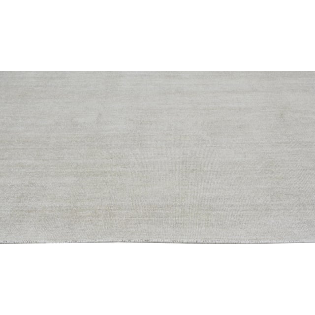 Hand-knotted with care using traditional rug making techniques, this wool rug blends timeless craftsmanship with a modern...