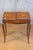 A stamped French Louis XV style small walnut slant-front desk with sliding inlaid panels, long drawer and inner...