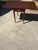 Rich mahogany grain, graceful tapered legs, and classic brass-tone hardware give this Henkel-Harris Pembroke table an...