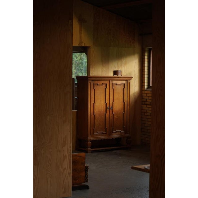 A characterful oak cabinet, made by a skilled Danish cabinetmaker dating from circa the 1950s. The cabinet features two...