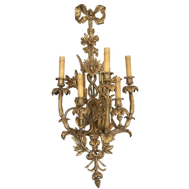 An exceptional and impressively scaled pair of French gilt bronze wall sconces, crafted with extraordinary detail and...
