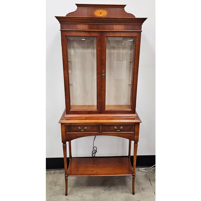 Good quality yew wood inlaid display cabinet on stand by Bradley. Coming in two main sections for ease of movement. Upper...