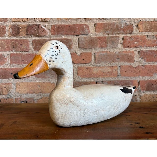 Vintage hand-carved white Pekin wooden duck decoy. Features beautiful hand-painted details, including a bright orange...