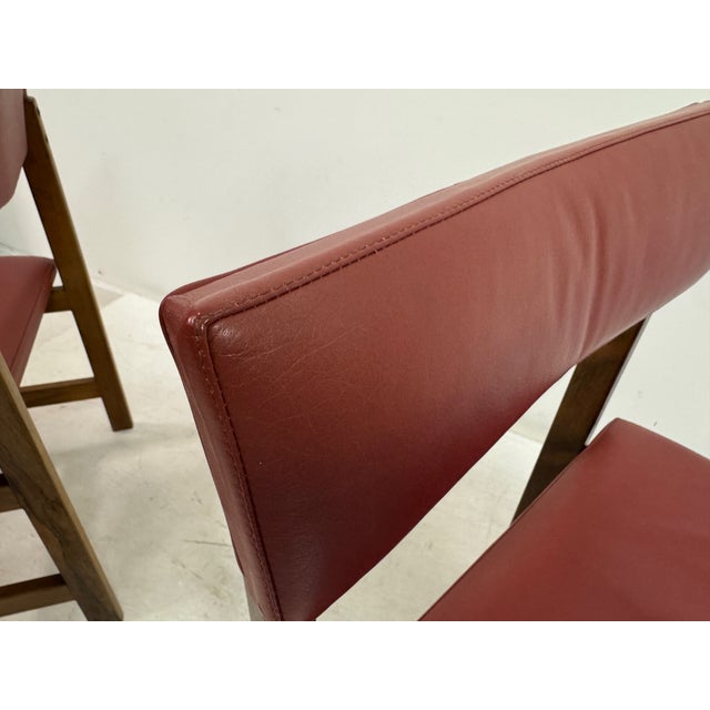 A set of six Danish dining chairs, dating to the 1960s, crafted in richly figured wood and defined by their clean,...