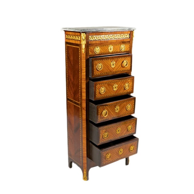 A 19th Century Transitional Style Five-Drawer Chiffonier with marble top and gilded bronzes mounts, handles and...