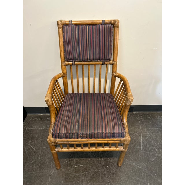 Eight Vintage Henredon Attributed bamboo-style dining chair with a solid rattan frame and original striped cushions....