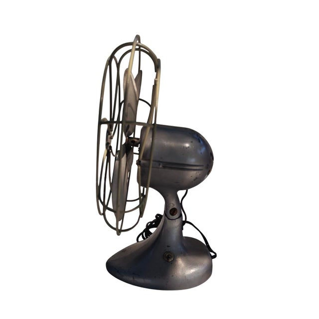 This is a Collectible vintage oscillating electric desk fan, Emerson brand featuring metal blades and industrial design....