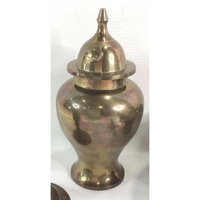 A striking pair of small vintage solid brass ginger jars, circa 1970s. These classic urn-form vessels feature generous...