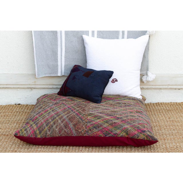 A vibrant expression of nomadic joy, this oversized floor cushion showcases the dazzling needlework of the Saami artisans....