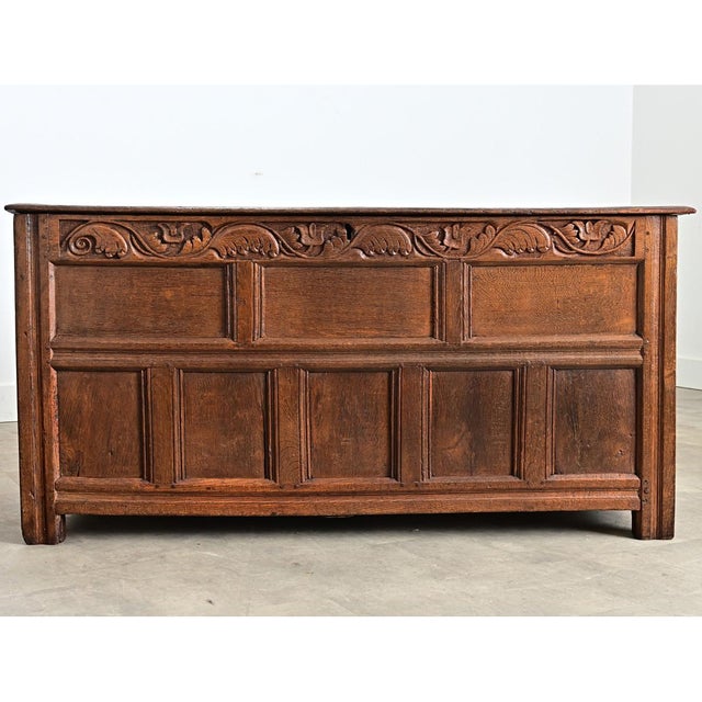 A French, solid oak coffer from the 1700s, this heavy storage trunk has a paneled exterior counterbalanced with...