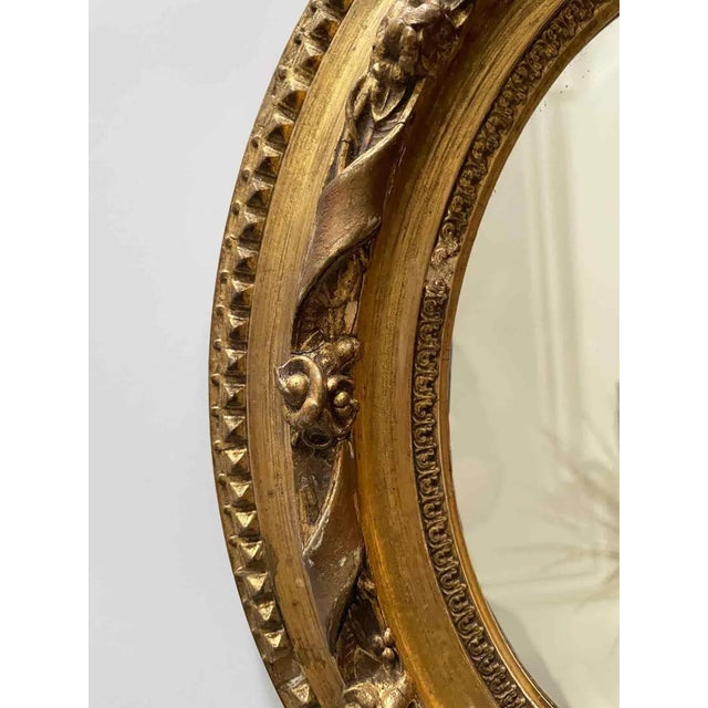 Early 20th century petite oval giltwood and gesso mirror.