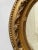 Early 20th century petite oval giltwood and gesso mirror.