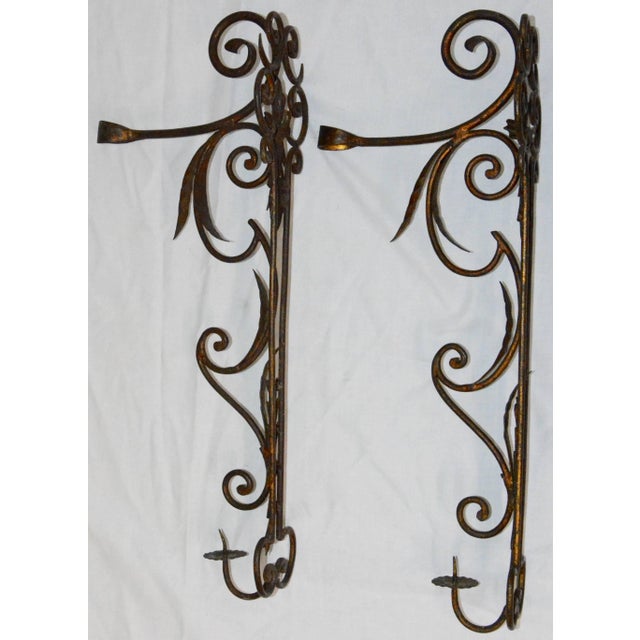 Featured is a unique pair of metal candleholder wall sconces. These are made of metal with a purposeful patina. They...
