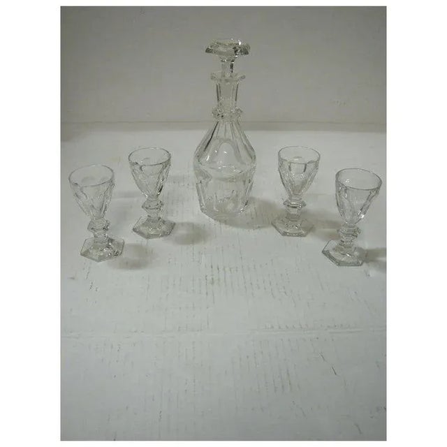 Beautiful signed baccarat decanter set with one decanter and four glasses that match. Decanter: Height: 8.5" Width: 3"...