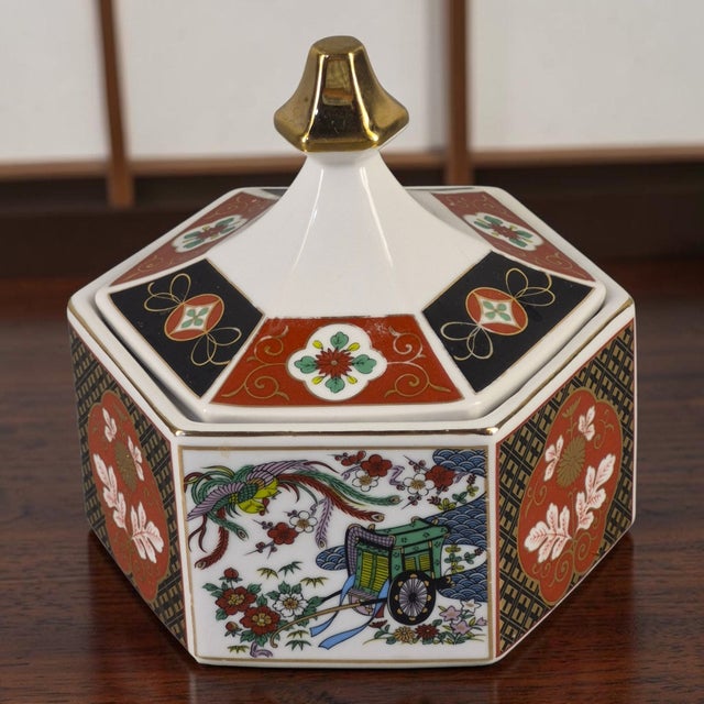 The Vintage Hexagonal Japanese Imari-Style Covered Trinket, Candy Dish is a charming and unique piece of Japanese culture....
