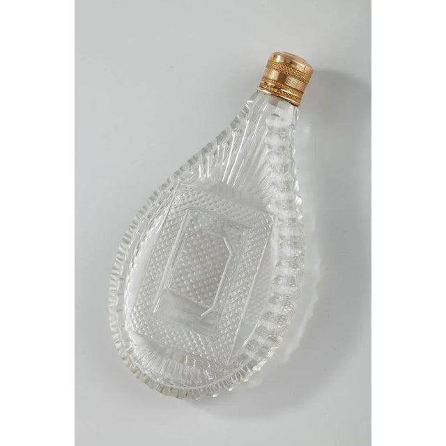 Teardrop-shaped flask in blown and cut crystal. It is embellished with several different decorative patterns: a ridged...