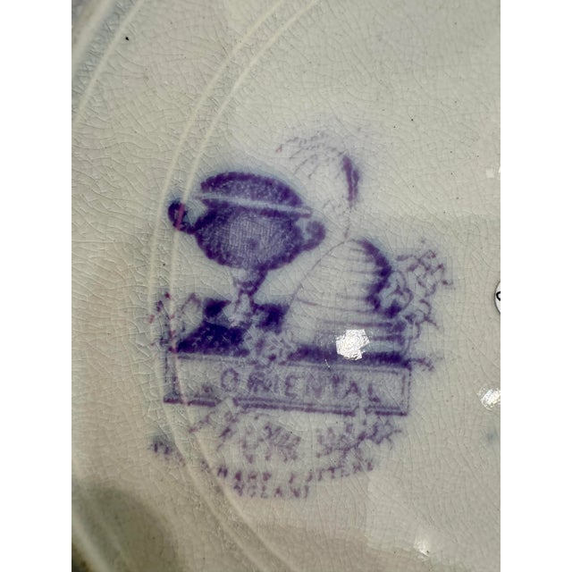 A rare find for collectors of fine English pottery — this Antique New Wharf London plate features a delicate lavender and...