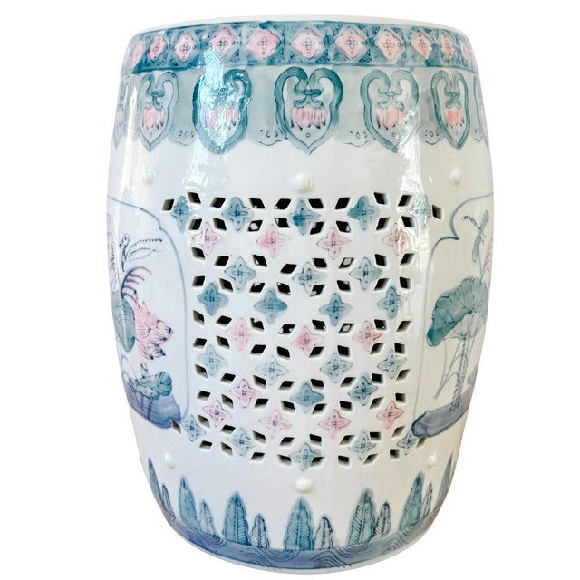 A vibrant green and pink Chinese porcelain garden stool featuring beautiful lotus flowers, dragonflies, cranes, and lucky...