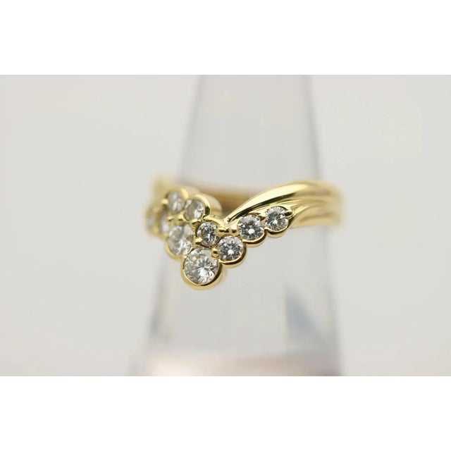 A classic V-shape diamond band with a unique and modern twist! It features 1.00 carat of larger round brilliant-cut...