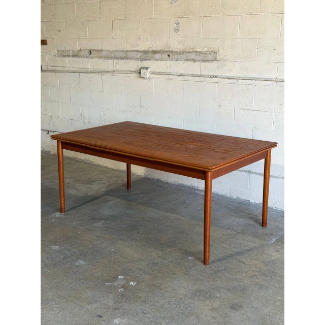 This expansive dining table features a minimalist profile and clean lines. Hidden extensions provide flexible seating...