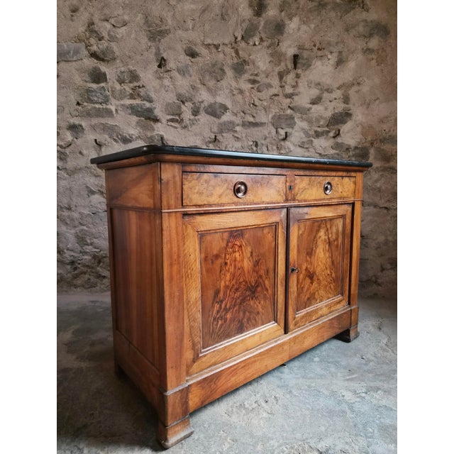 A French Louis Philippe buffet dating from around 1840–1860. The cabinet is made of walnut and burr walnut veneer and...