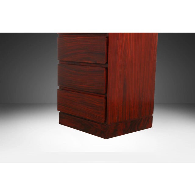 Rare, attractive Danish modern, sleek, rosewood, eight-drawer tall, narrow, lingerie chest of drawers. Designed by Arne...