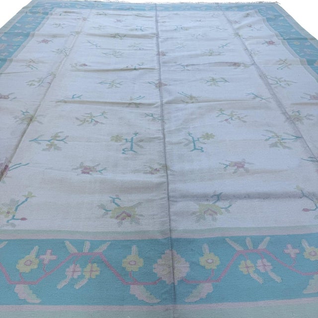 This handmade Indian dhurrie (flatweave kilim-style) rug is a celebration of simplicity, craftsmanship, and soft, refined...