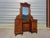 A solid walnut dressing table in the Louis XVI style. It features a large, rounded mirror with beveled edges at the top...