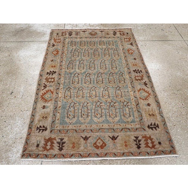 This Mid-20th century Persian Malayer rug, measuring 3' 5" x 5' 0", presents a refined example of the village weaving...