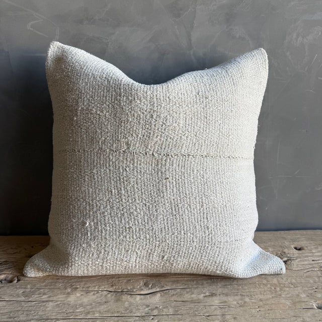 Creamy white hemp rug pillow with original seams. Soft hand, linen blend backing with zipper closure. Spot cleaning is...