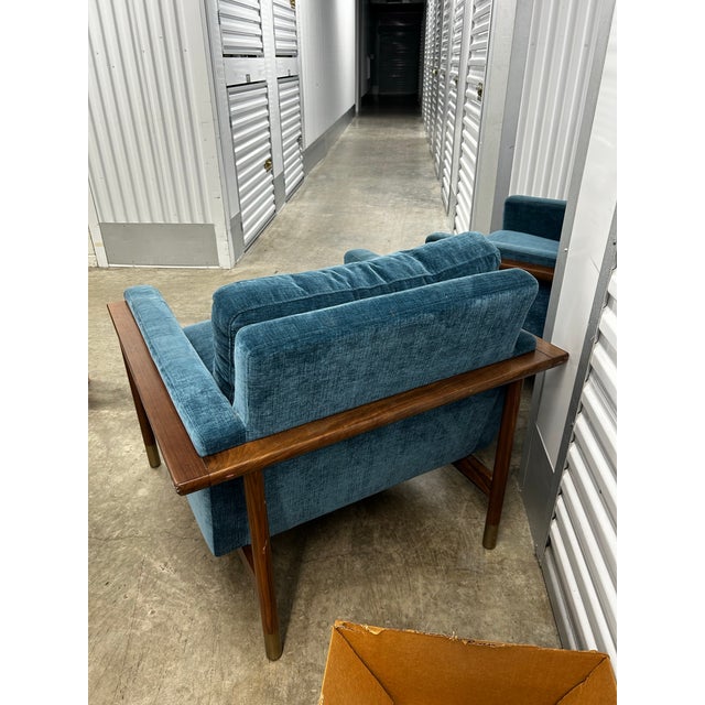 Gorgeous pair of mid century inspired lounge chairs designed by Jason Wu for Interior Define. Walnut frame, brass detail...