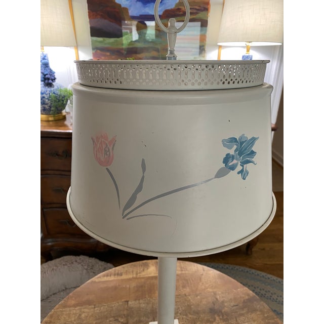 Absolutely lovely vintage toleware lamp in soft eggshell off white width delicate pink and blue painted flowers. Would be...
