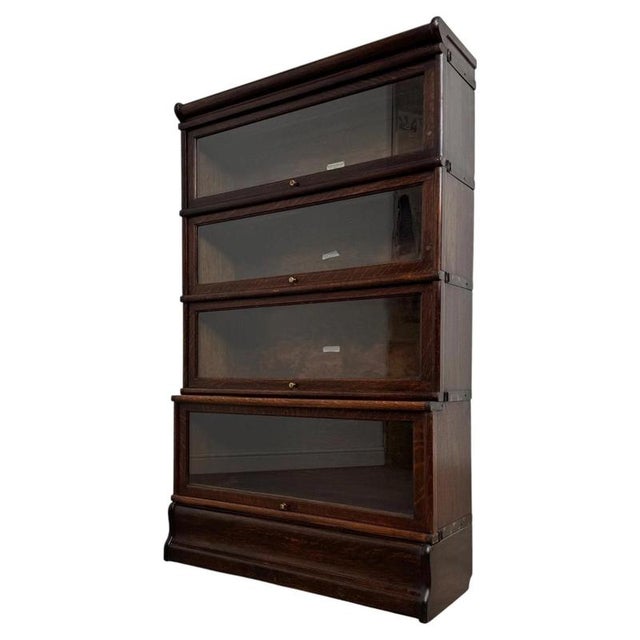 A fine early 20th-century Globe-Wernicke stacking bookcase, beautifully crafted from oak and distinguished by its modular...