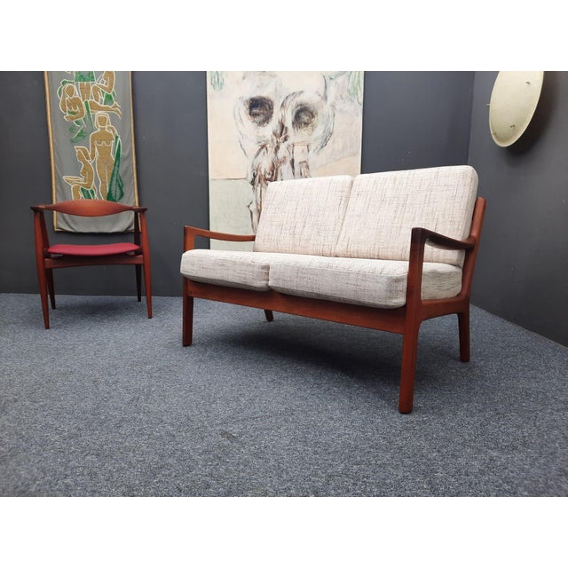 A very beautiful teak design classic by Ole Wanscher. Manufacturer: Cado. Senator model from the 1960s. The two-seater was...