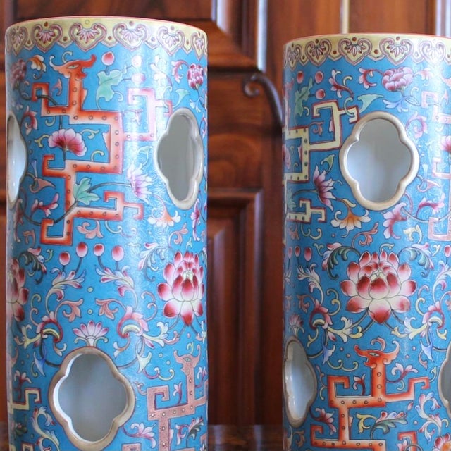 A beautiful pair of polychrome porcelain cylinders, with bright enameled zoomorphic and foliate decoration in orange,...