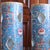 A beautiful pair of polychrome porcelain cylinders, with bright enameled zoomorphic and foliate decoration in orange,...