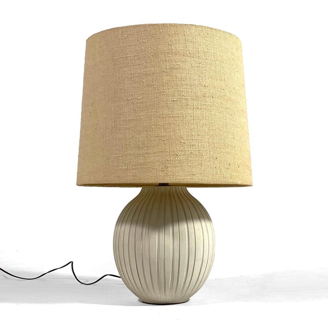This exceptional table lamp has a hand made ceramic base in an onion shape with vertical incised lines. The original shade...