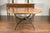 A French dining table with round parquetry top from the early 20th century and new custom iron base. Capturing our...