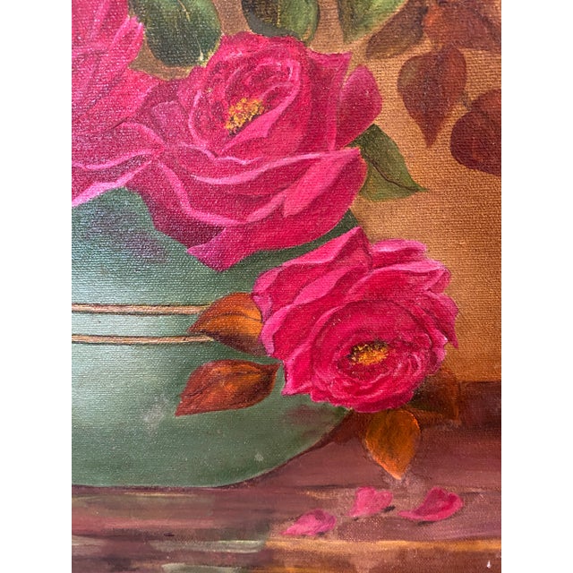 Gorgeous bouquet of hot pink roses arranged in a turquoise vase. The roses are in various states of blooming - there are...