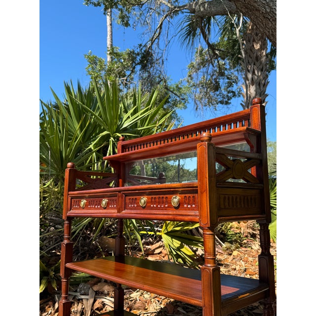 A charming vintage mahogany cheveret bar cart showcasing timeless traditional style and exceptional versatility. Featuring...