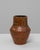 20th Century German Ceramic Vase. This expressive vase features a rich burnt sienna glaze with embossed motifs and...