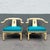 A striking pair of vintage Ming-style horseshoe lounge chairs featuring elegantly curved armrests and a classic Asian-...