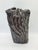 A unique, handcrafted ceramic vase with an expressive, organic form inspired by nature. The body is adorned with fluid,...