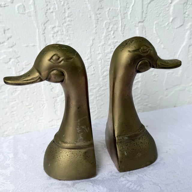 A charming pair of vintage Mid-Century brass duck bookends featuring clean sculptural lines and stylized forms...